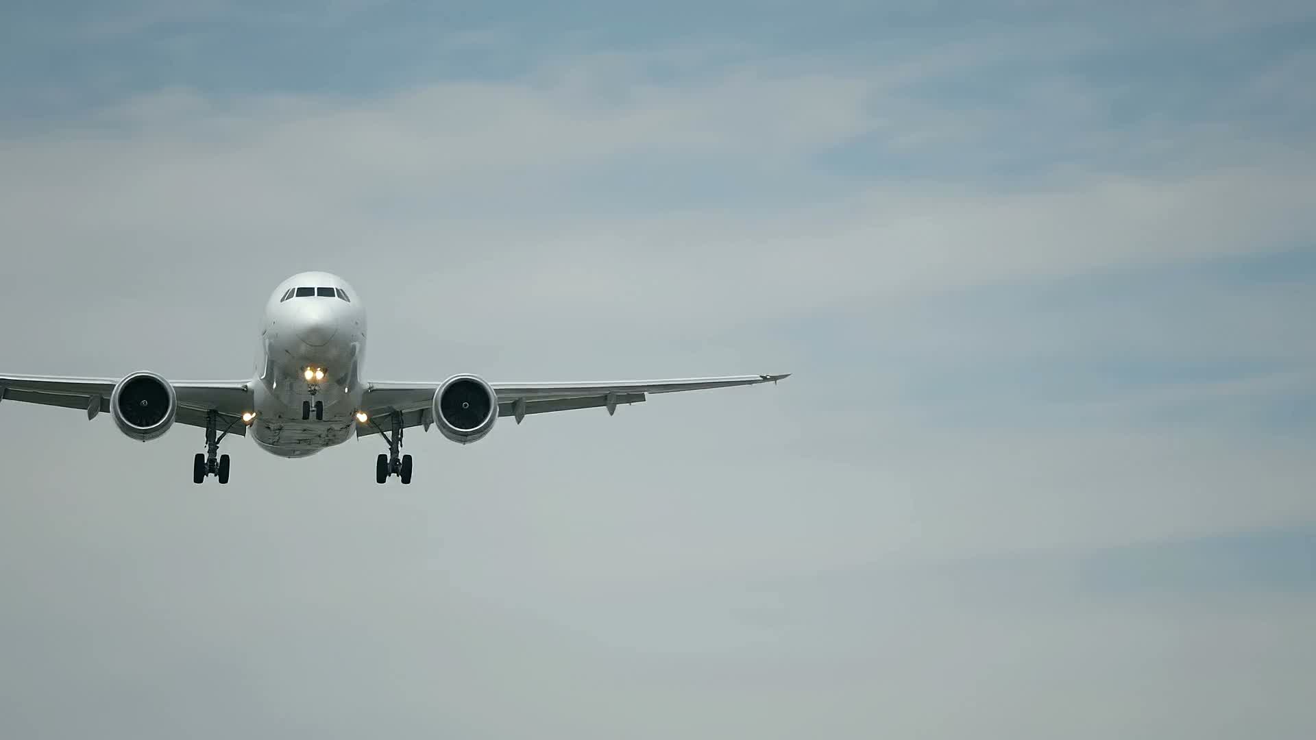 An aircraft on final approach, seen head-on against open sky