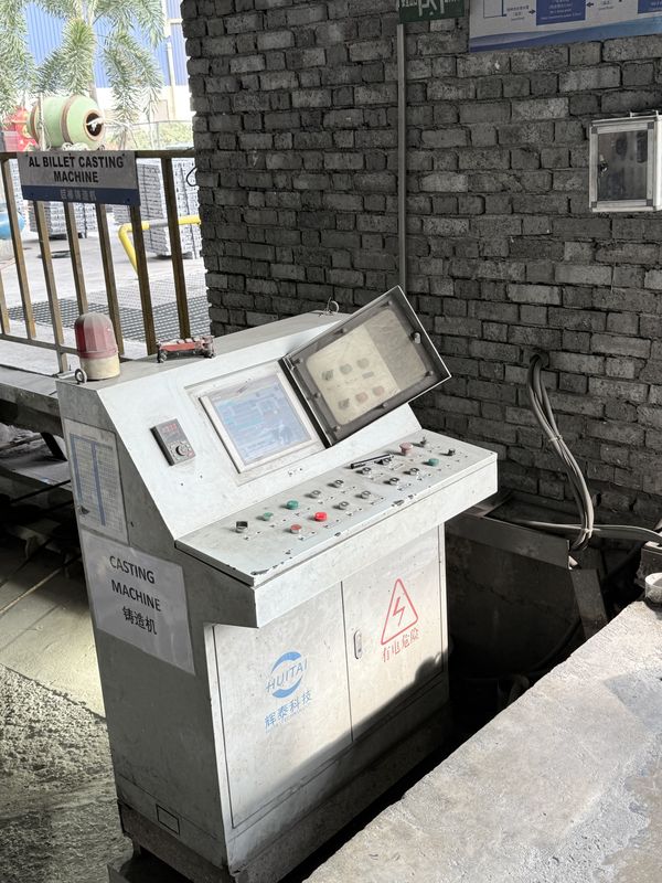 The control cabinet of the aluminium billet casting machine, beside the casting pit