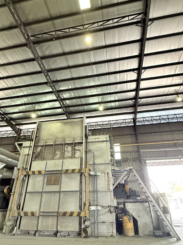 The homogenizing furnace, its door framed in hazard striping