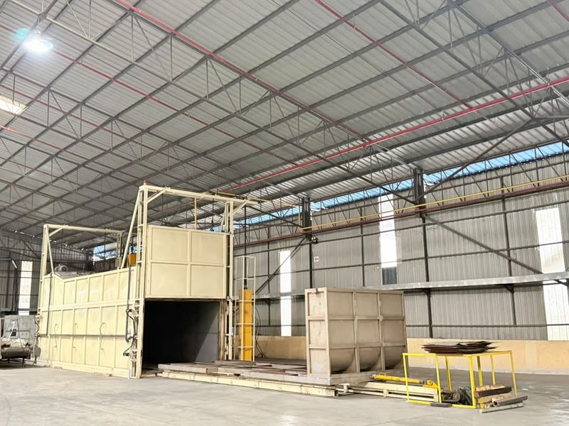 Two artificial ageing furnaces in the extrusion hall, one with its charging door open