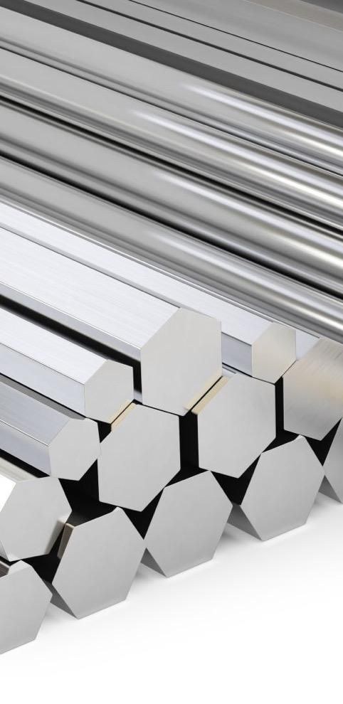 Aluminium bar stock with hexagonal end faces, stacked beside longer sections
